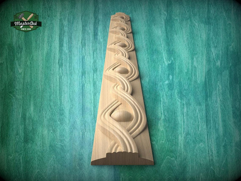 a wooden carving of a decorative design on a wooden surface, set against a green background.