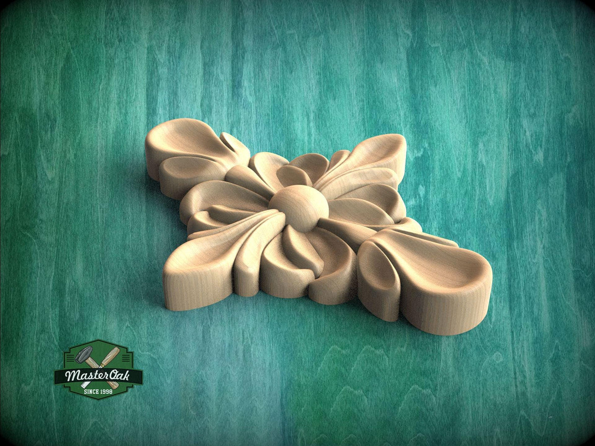A wooden carving of a flower-like design is displayed against a green background.