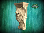 A carved wooden lion head with a fierce expression is displayed against a green wooden background.