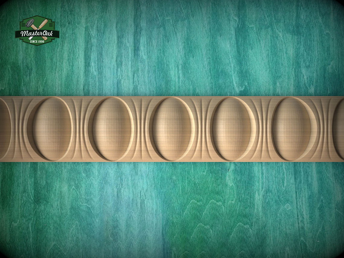 a close-up view of a wooden border with a repeating pattern of oval shapes, set against a textured green background.