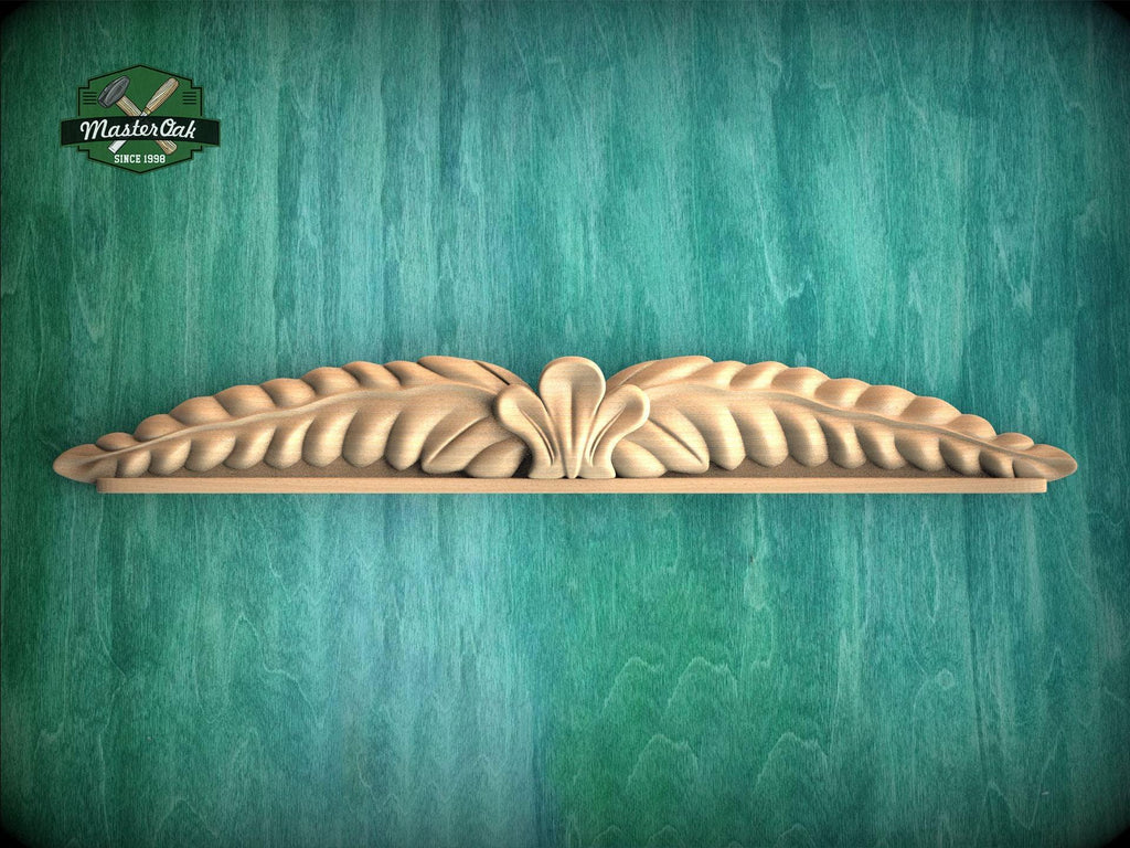 A decorative wooden carving of a leaf-like design is displayed against a green textured background.