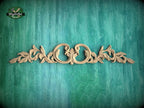 a decorative wooden carving on a green textured background.