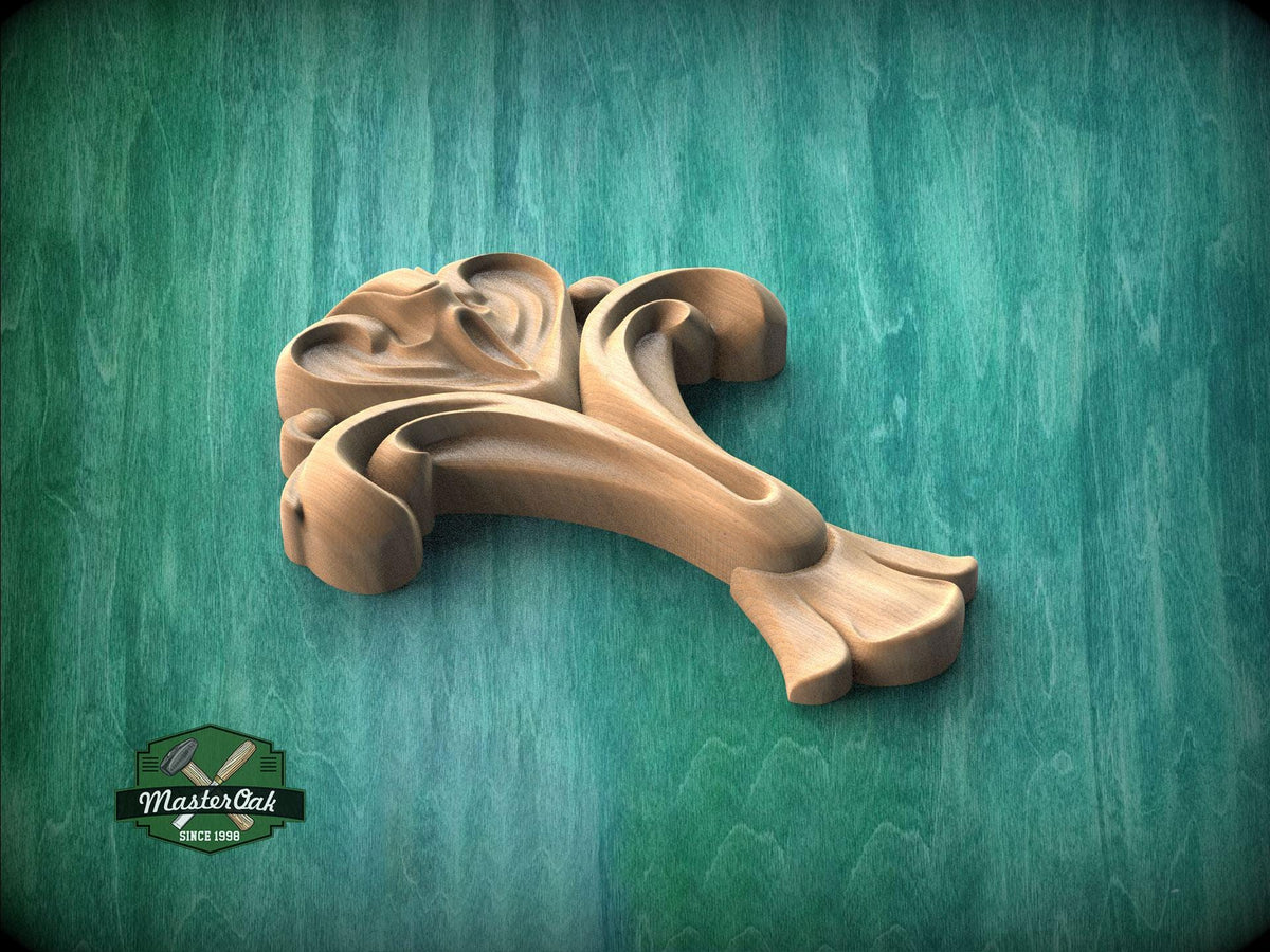 A wooden carving of a stylized flower or plant is displayed against a green background.