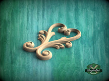 Load image into Gallery viewer, A wooden carving of a heart shape is displayed against a teal background.
