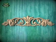 Load image into Gallery viewer, a decorative wooden carving on a green background.
