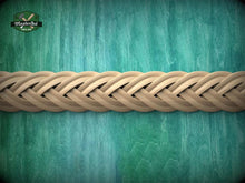 Load image into Gallery viewer, A close-up view of a braided wooden object, possibly a piece of furniture or a decorative item, set against a textured green background.
