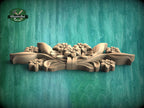A wooden carving of a floral design is displayed against a green background.