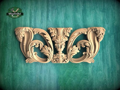 an ornate carved wooden piece with intricate floral designs, displayed against a green background.