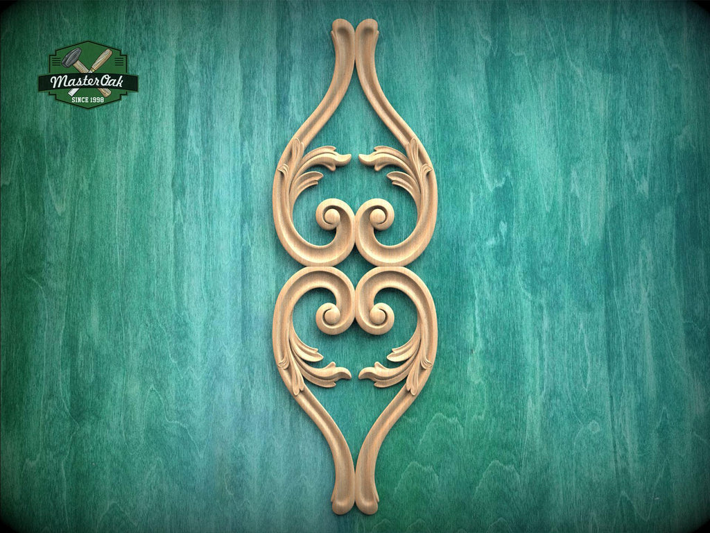 a decorative wooden carving of a stylized floral design on a green background.