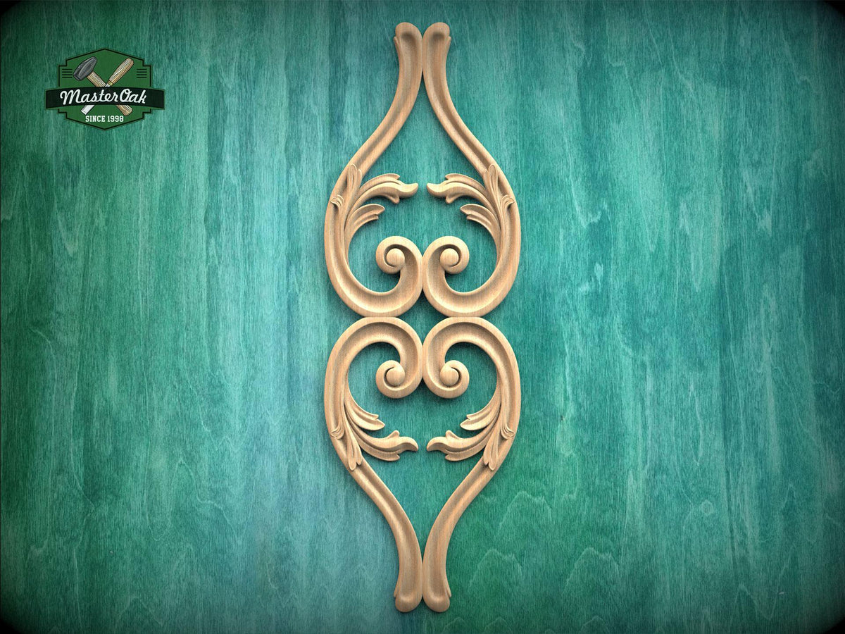 a decorative wooden carving of a stylized floral design on a green background.