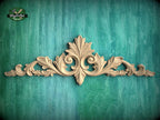 a decorative wooden carving on a green background.