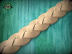 A wooden braided object is displayed against a teal-colored background.