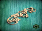 A decorative wooden carving with intricate floral and leaf-like patterns is displayed against a green textured background.