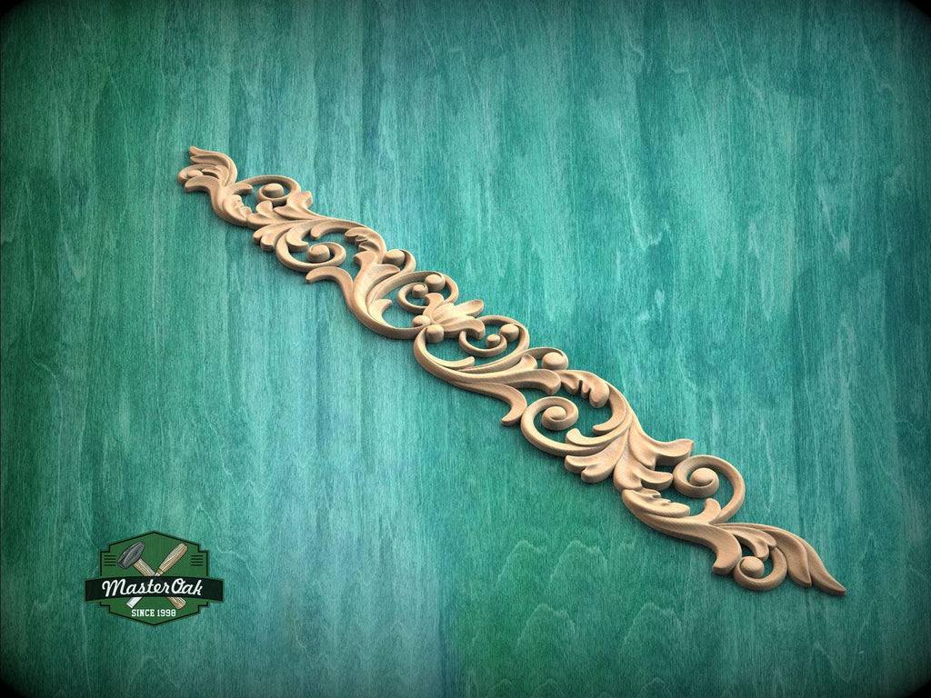 a decorative wooden carving or mold on a green textured background.