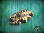 A wooden carving of a flower is displayed against a green background.