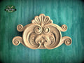 a beautifully carved wooden design on a green background.
