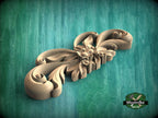 A wooden carving with intricate floral designs is displayed against a green background.