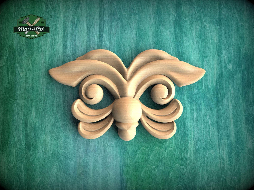 A wooden carving of a butterfly-like design is displayed against a green background.