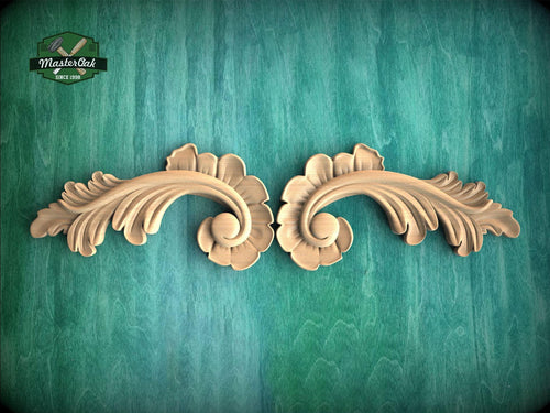 a pair of carved wood carvings on a green background