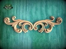 Load image into Gallery viewer, a wooden carving of an ornate design on a green background
