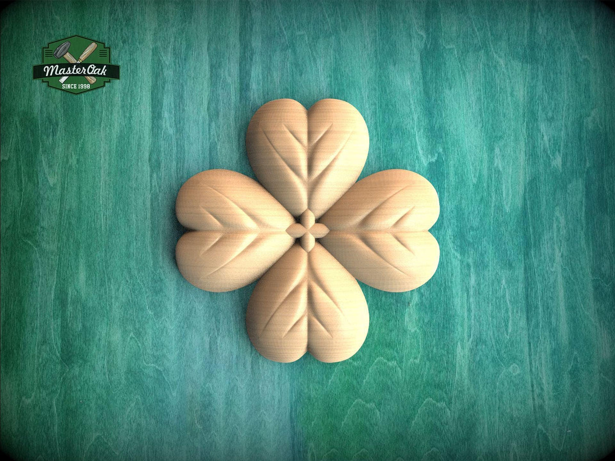 A wooden four-leaf clover design is centered against a green background.