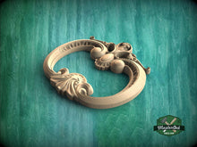 Load image into Gallery viewer, A wooden ornate carving or sculpture is displayed against a green textured background.
