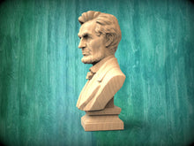 Load image into Gallery viewer, A wooden bust of Abraham Lincoln, a famous American president, is displayed against a green wooden background.
