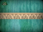 a decorative border made of carved wood, set against a textured green background.
