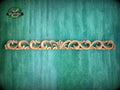 a green wall with a wooden carving on it