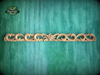 a green wall with a wooden carving on it