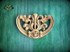 a decorative wooden carving on a green background.