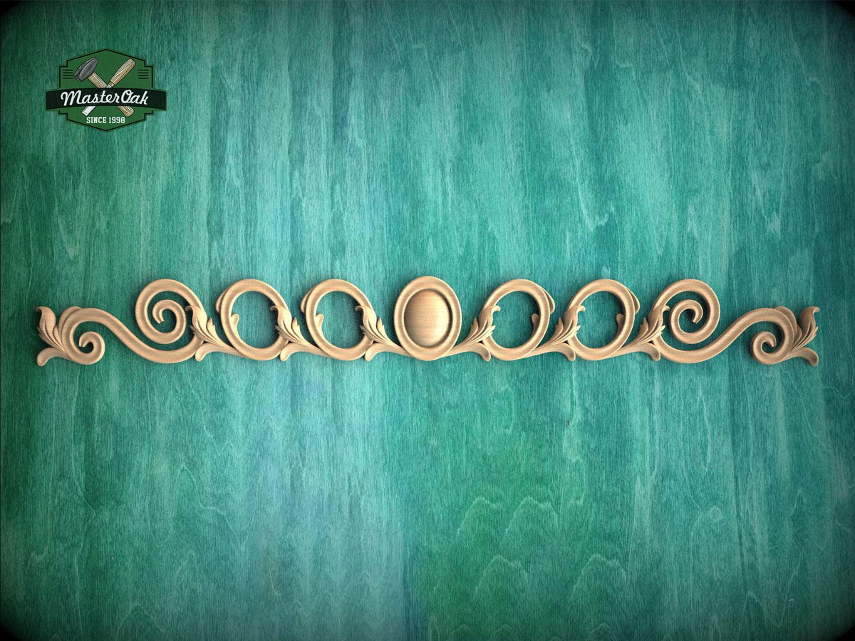 a decorative wooden piece with a floral design, placed against a green background.