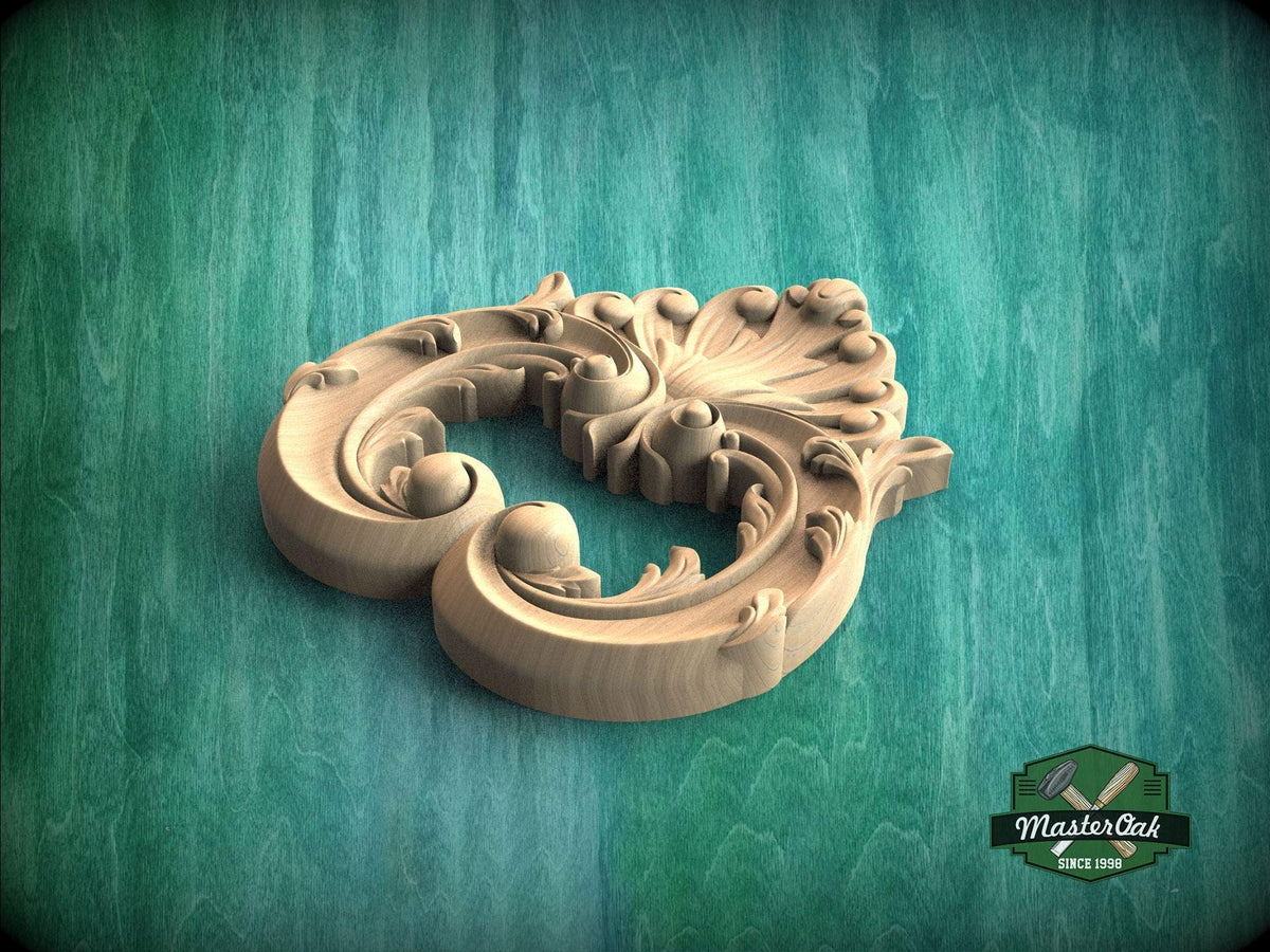 A carved wooden piece with an intricate floral design sits on a green textured background.