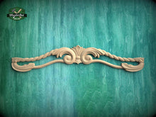 Load image into Gallery viewer, A decorative wooden carving of a floral design is displayed against a green textured background.
