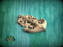 Load image into Gallery viewer, A wooden anchor with intricate carvings is displayed against a teal-colored background.
