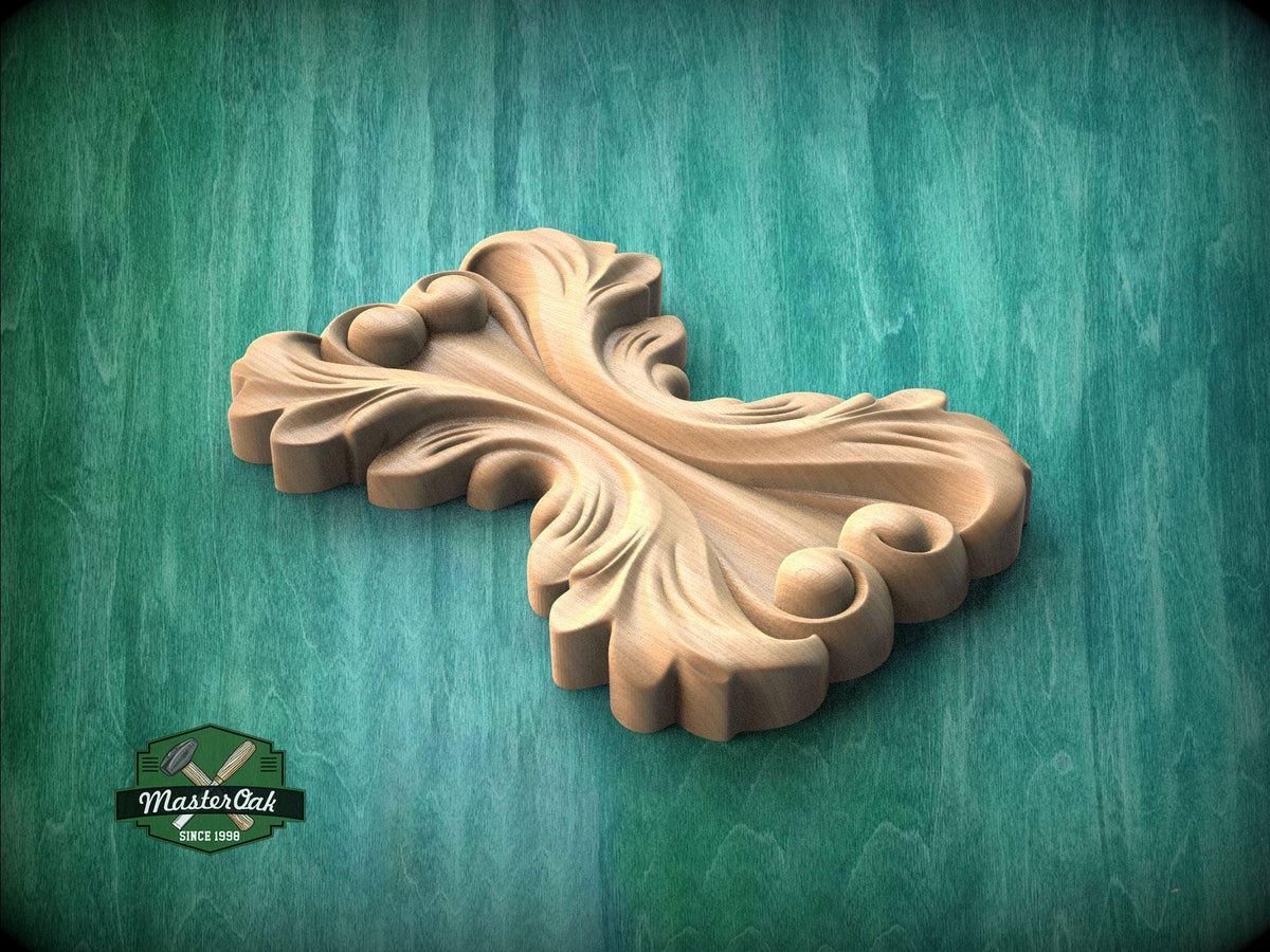 A wooden carving of a stylized leaf or flower design is displayed against a green background.