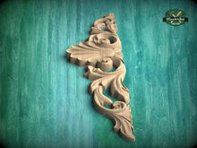 Load image into Gallery viewer, A decorative wooden carving with an intricate floral design is displayed against a green textured background.
