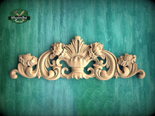 Load image into Gallery viewer, a decorative wooden carving on a green background.
