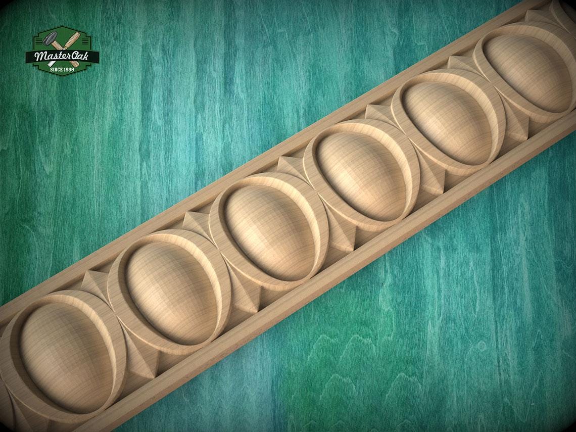A wooden decorative border with a repeating pattern of oval shapes is displayed against a green background.