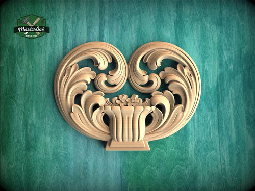 a decorative wooden carving of a heart shape, with intricate scrollwork and floral elements, set against a green background.