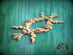 A wooden carving of a floral design is displayed against a green background.