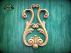 a decorative wooden carving on a green background.