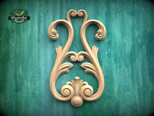 Load image into Gallery viewer, a decorative wooden carving on a green background.
