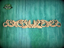 Load image into Gallery viewer, a decorative wooden carving on a green textured background.
