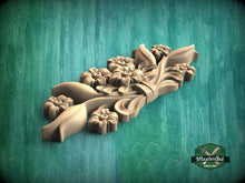 Load image into Gallery viewer, A wooden carving of a flower design is displayed against a green background.
