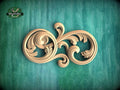 a decorative wooden carving on a green background.