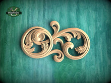 Load image into Gallery viewer, a decorative wooden carving on a green background.
