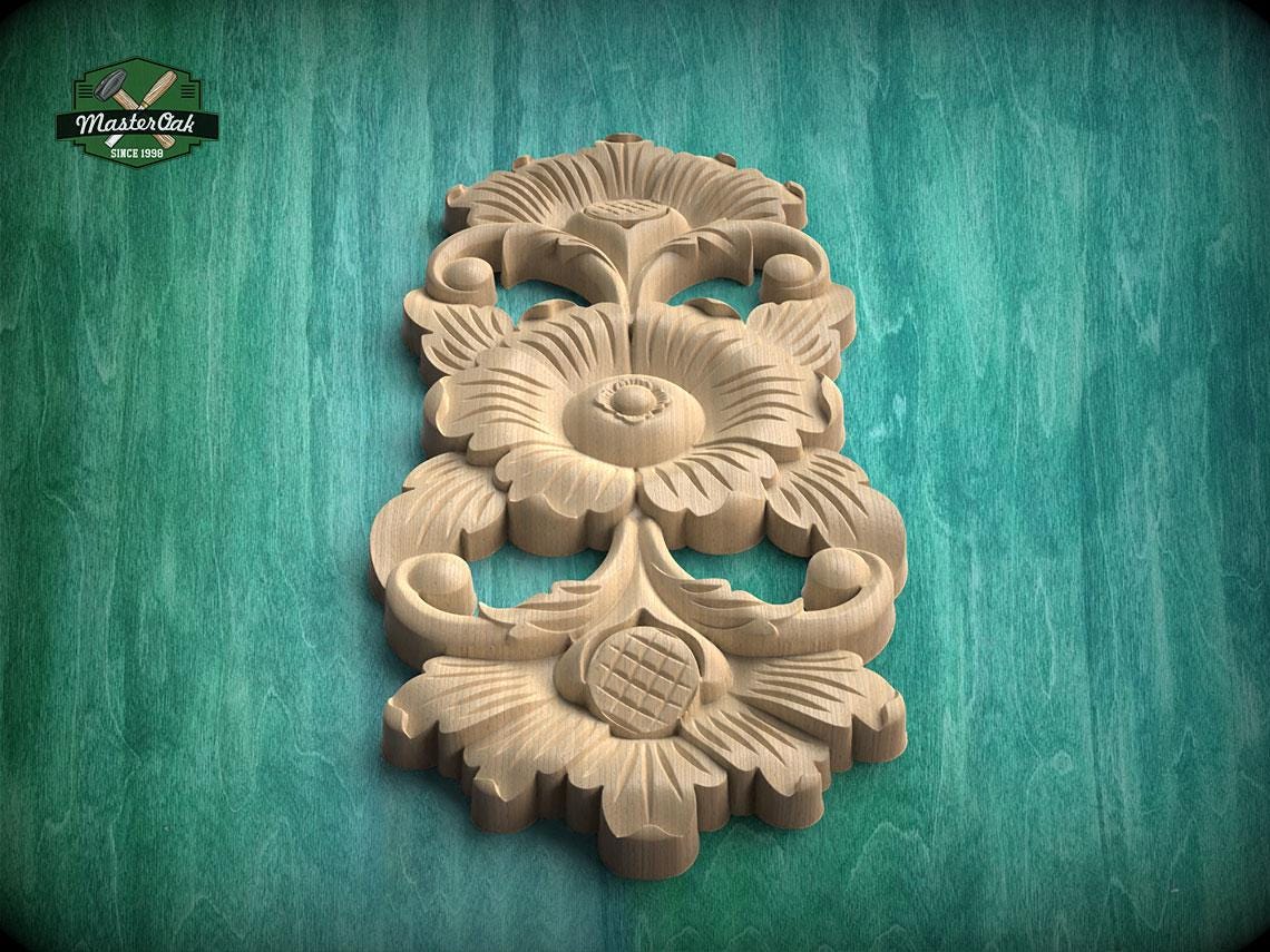 A wooden carving of a flower with intricate details is displayed against a green background.