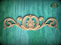 a decorative wooden carving on a green background.