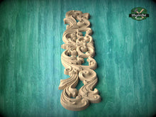Load image into Gallery viewer, A decorative wooden carving in the shape of a swirl or scroll is displayed against a green background.
